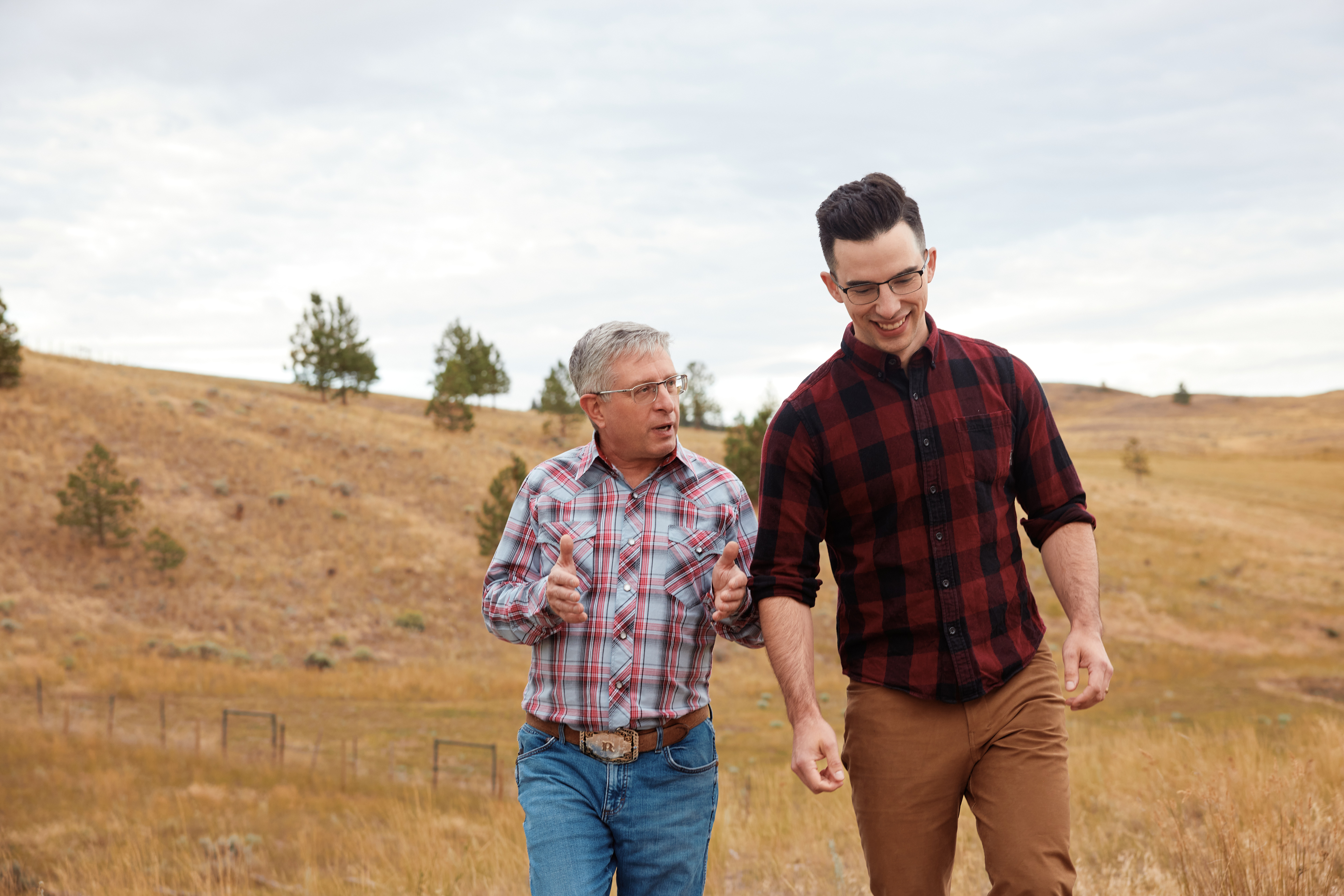Dr. David Rushka and Dr. Doug Whitelaw walking together through the Kamloops grasslands